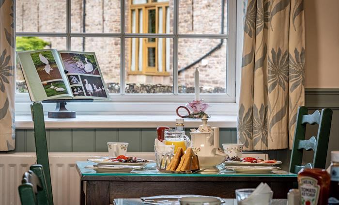 Tasty breakfast with great views from our breakfast room, including locally made sausages and thick bacon.